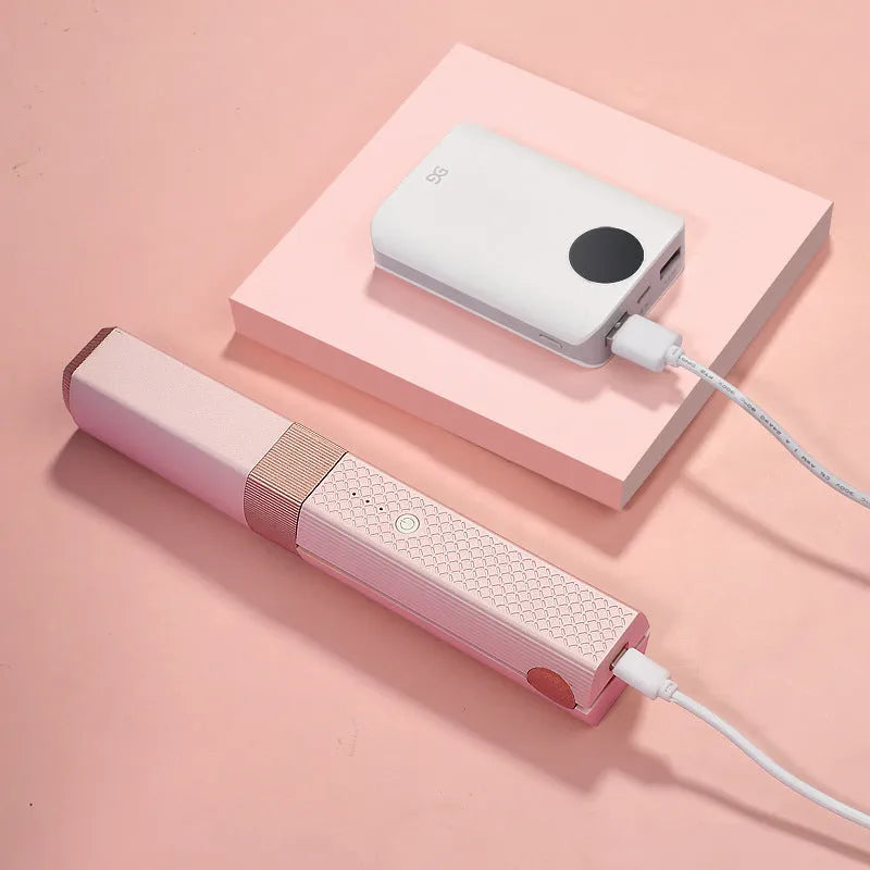 Pink and green cordless USB hair straightener with ceramic plates and digital temperature display.