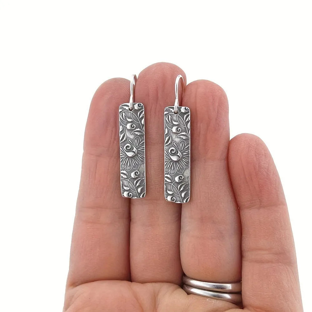 Silver long earrings with geometric shapes and carved vine detailing in zinc alloy construction