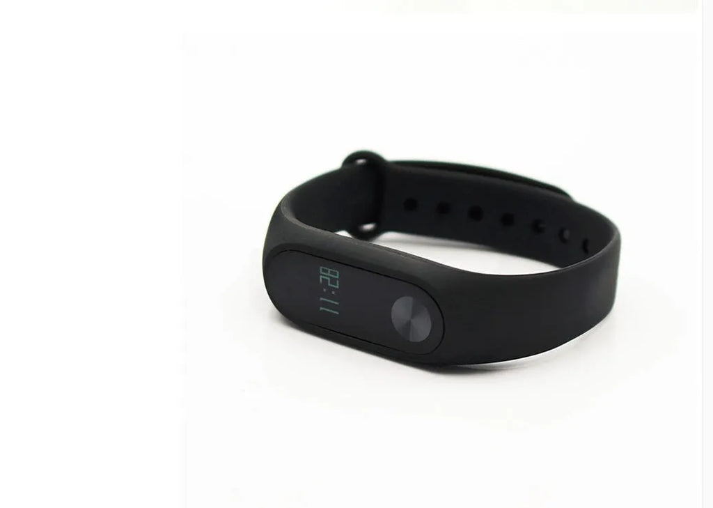 Black Xiaomi Mi Band 2 smart band with OLED display on a wrist, showing heart rate.
