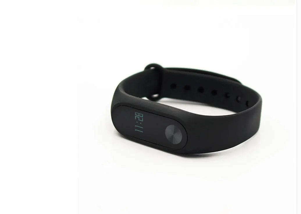 Black Xiaomi Mi Band 2 smart band with OLED display on a wrist, showing heart rate.