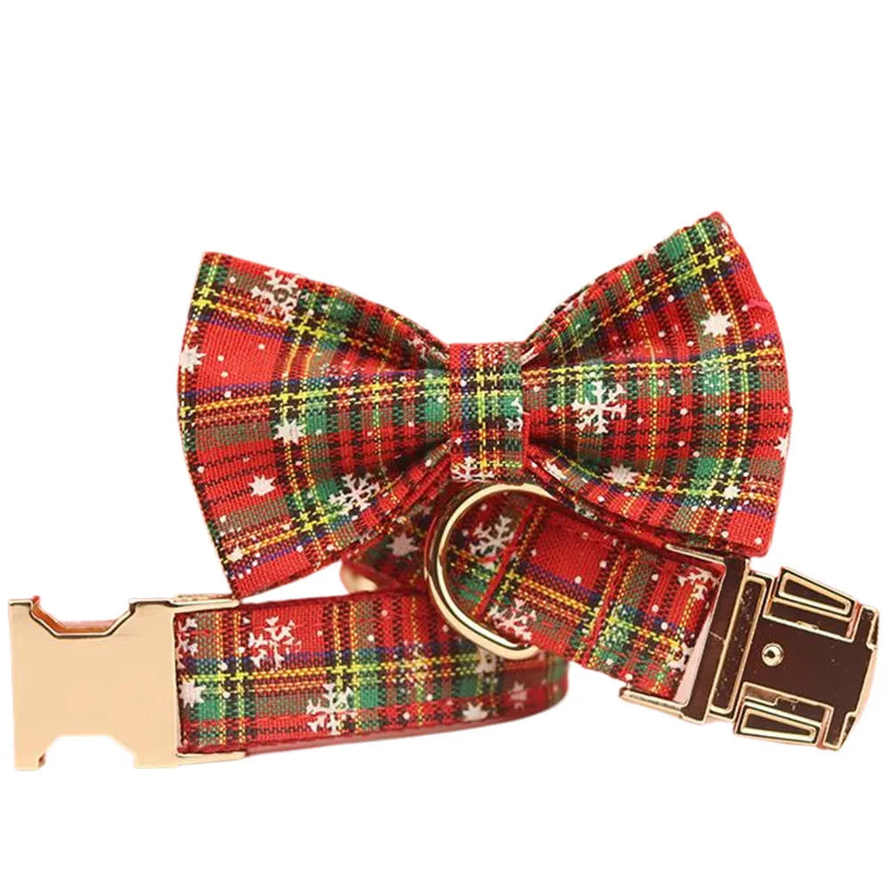 Four-piece Christmas pet accessory set with red snowflake collar, plaid leash, festive vest, and bow tie