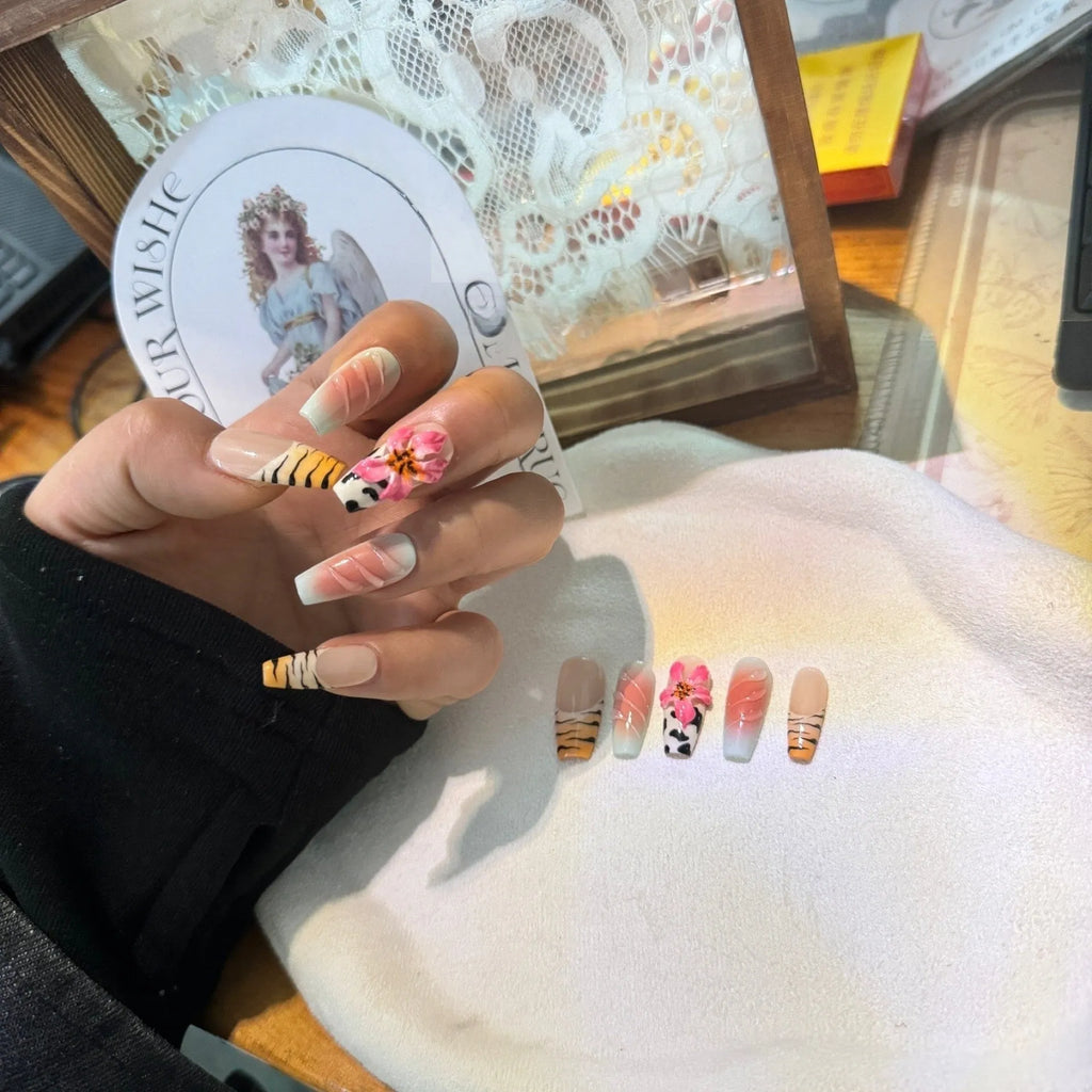 Set of false nails with hand-carved zebra pattern and lily design, showing sizes XS S M L and leopard print styles.