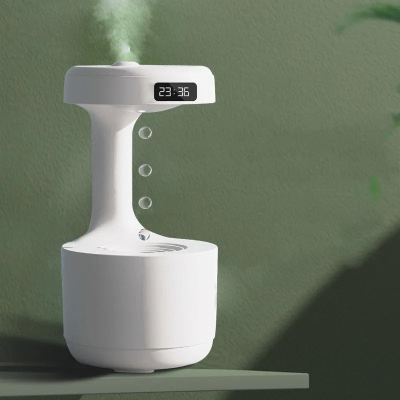 White columnar anti-gravity humidifier with LED clock display and mist output on a wooden desk.