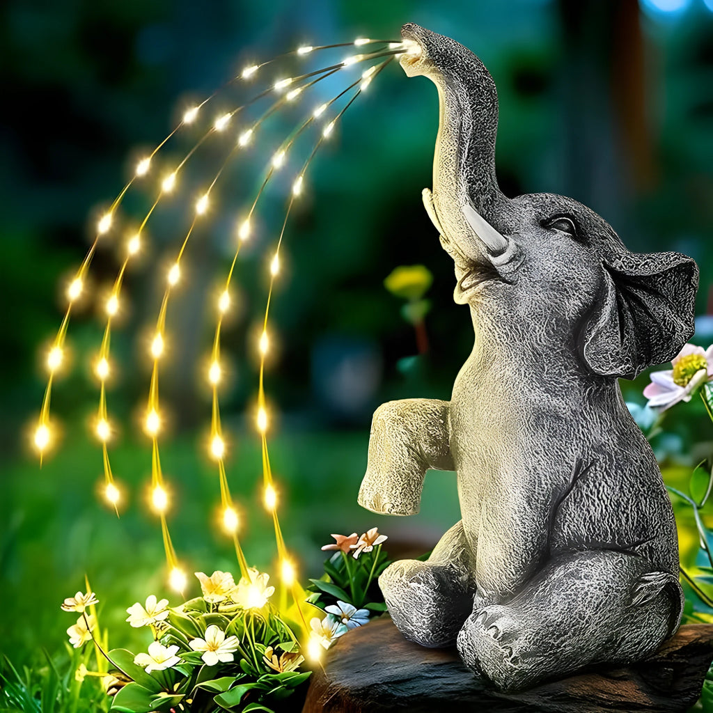 Resin elephant outdoor garden sculpture with integrated warm white LED lighting on the statue.