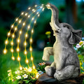Resin elephant outdoor garden sculpture with integrated warm white LED lighting on the statue.