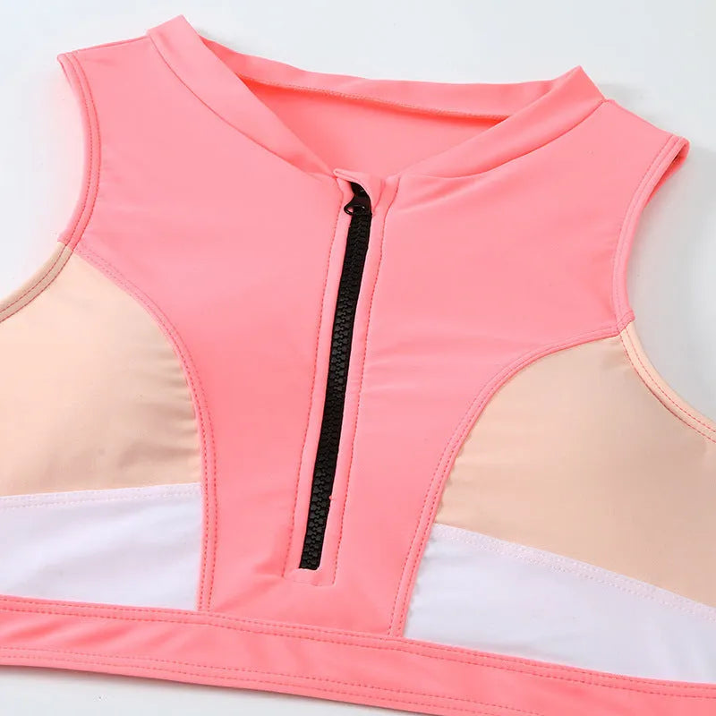 Pink high waist split bikini swimsuit set on a model, showing the brief style and sleeveless top.