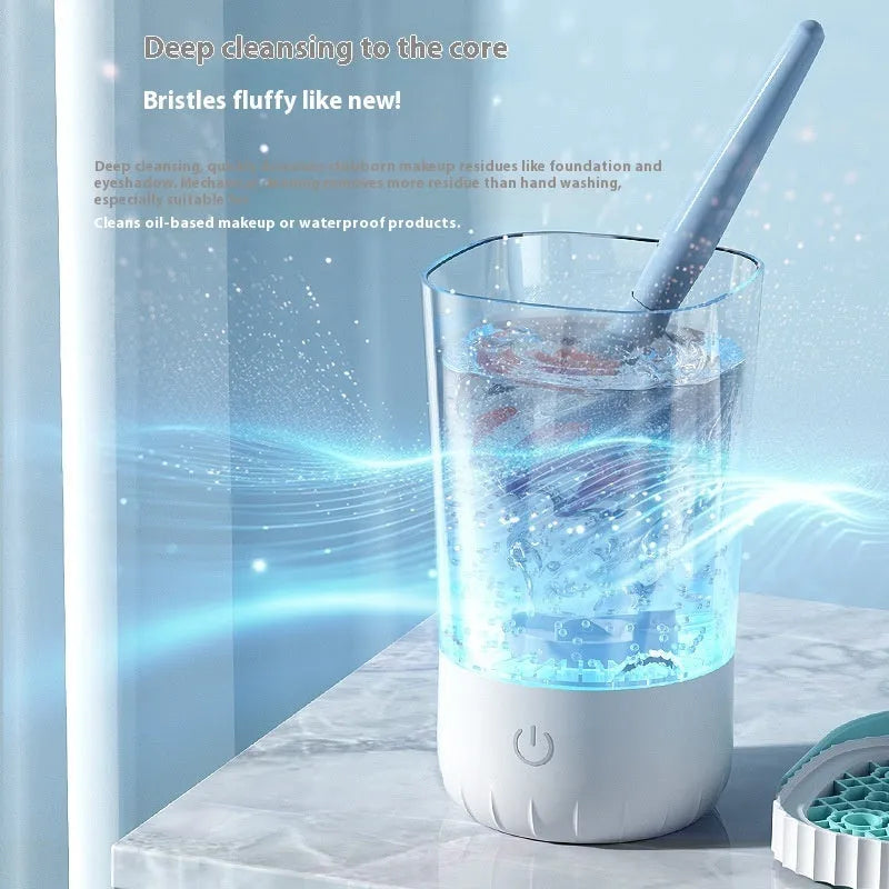 White rechargeable electric makeup brush cleaning device with data cable.