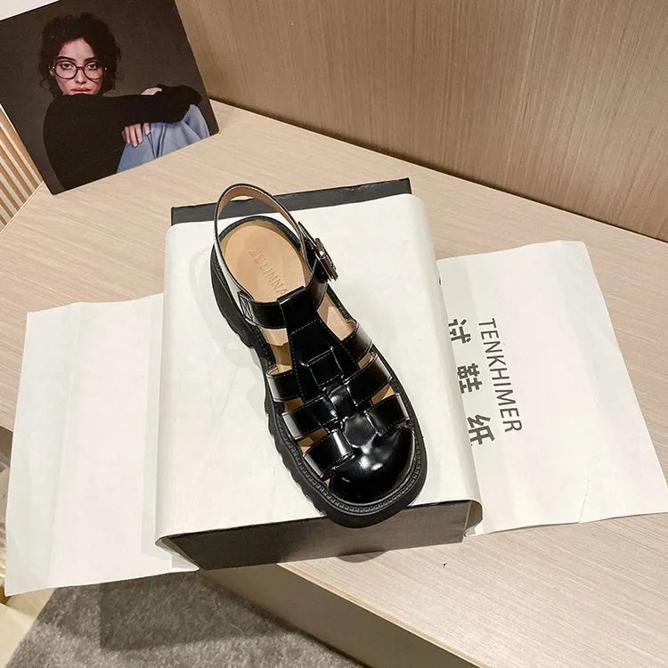 Women's black retro platform sandals with chunky heel, hollow out design, and a buckle fastening.