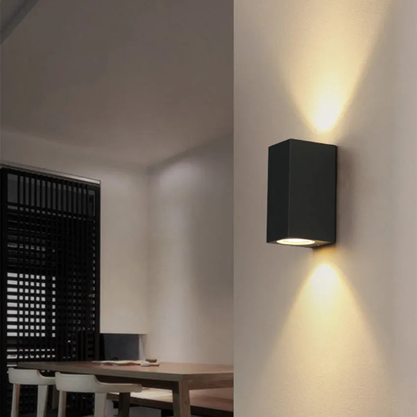 Modern black aluminium LED wall lamp with glass shade and silicone rubber trim.