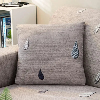 Printed geometric pattern stretch sofa slipcover fitted on a modern three-seater sofa.