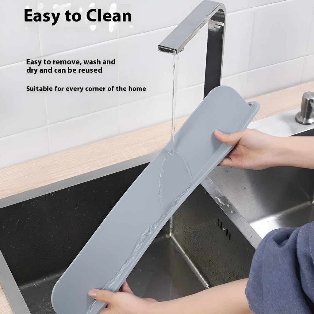 Grey silicone kitchen sink splash guard plate measuring 52mm by 85mm