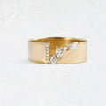 Gold electroplated copper ring for women with shining zircon details, shown on a finger.