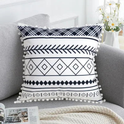 Bohemian national style polyester cushion cover in light grey on a sofa.