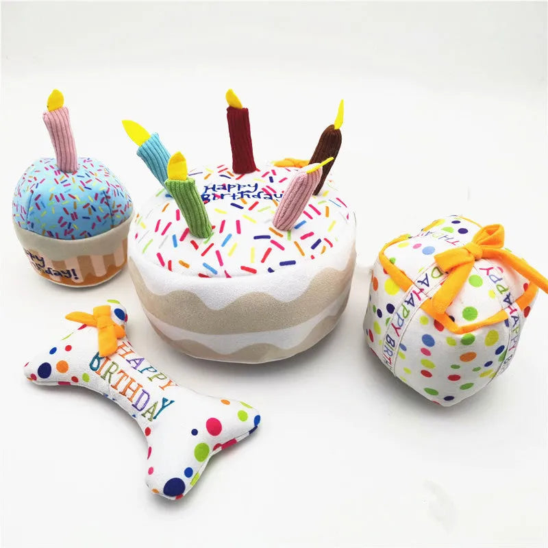 Four-piece dog birthday cake plush toy set including big cake, small cake, gift box, and bone on white background