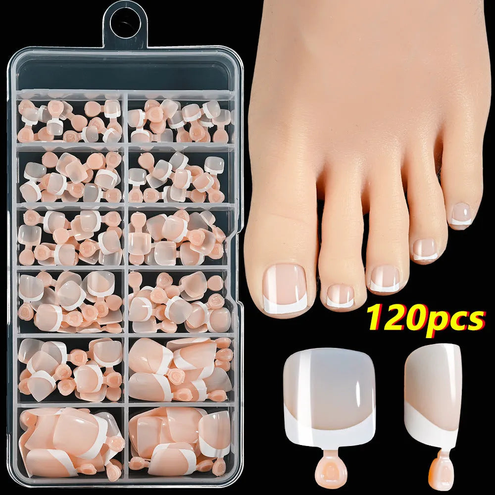 120 piece boxed set of full square short artificial toenails with French white edge design on nude base