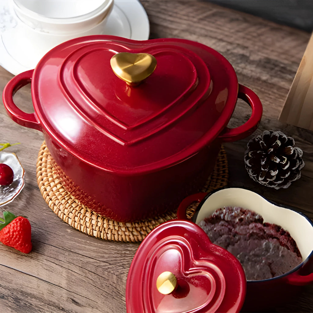 Heart-shaped cast iron enamel stewing pot with lid on stovetop, 11cm diameter