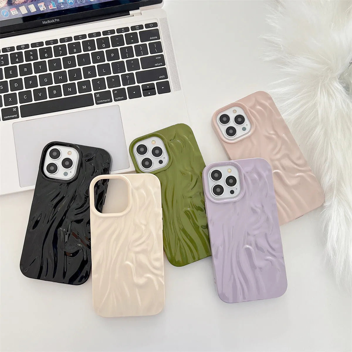 Solid colour water ripple texture silicone case for iPhone on a table.