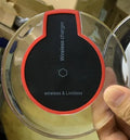 Black wireless charging pad compatible with Samsung Galaxy and iPhone smartphones