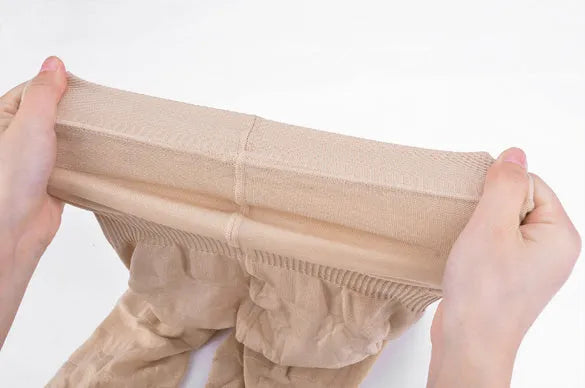 Women's black seamless high-waist shapewear shorts for tummy control.