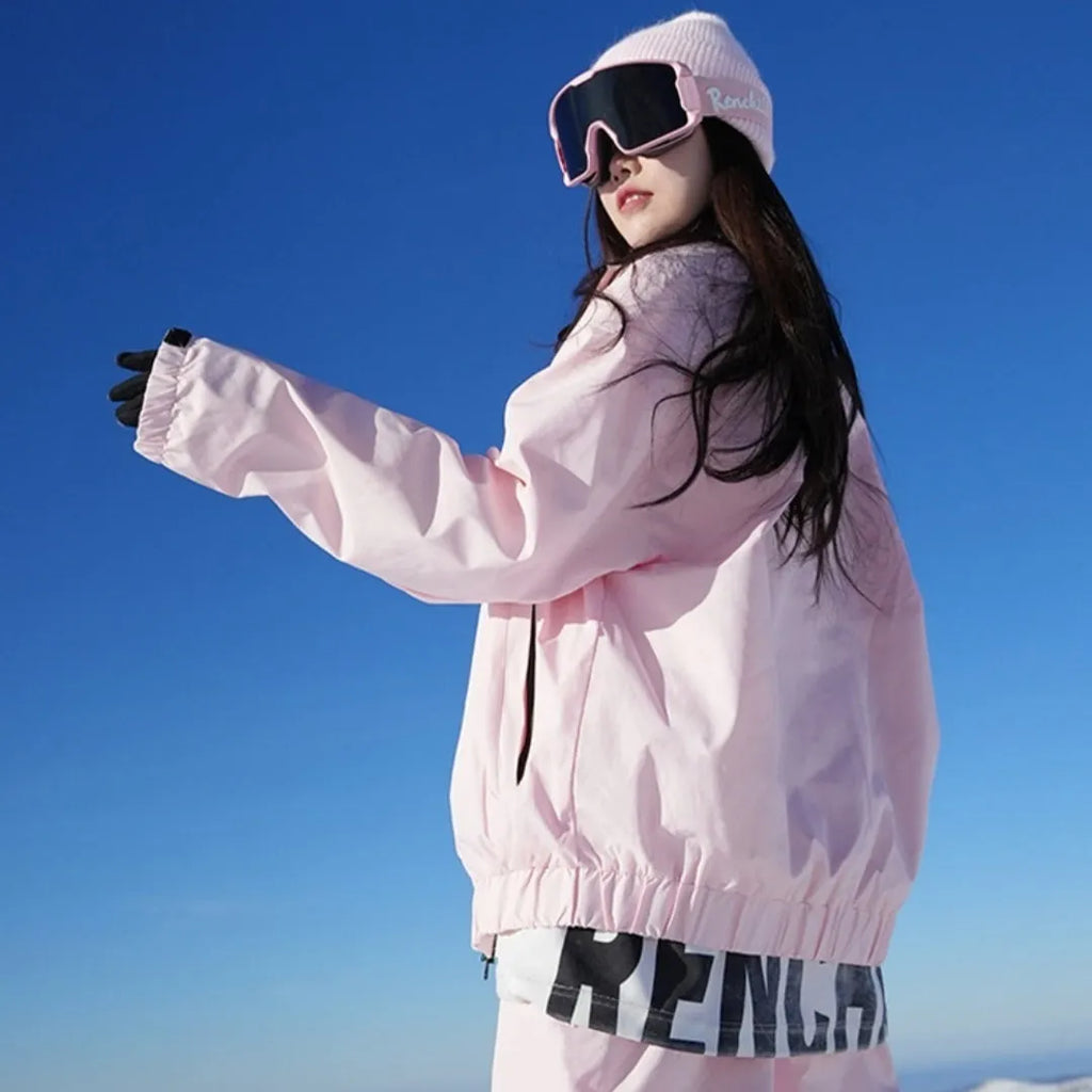 Pink and black waterproof cotton blend winter ski suit jacket and trousers set on hanger
