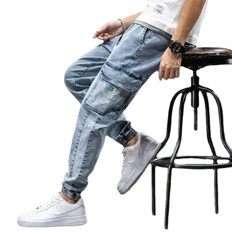 Man wearing loose straight-leg cargo jeans in blue, showing Korean-style casual workwear.