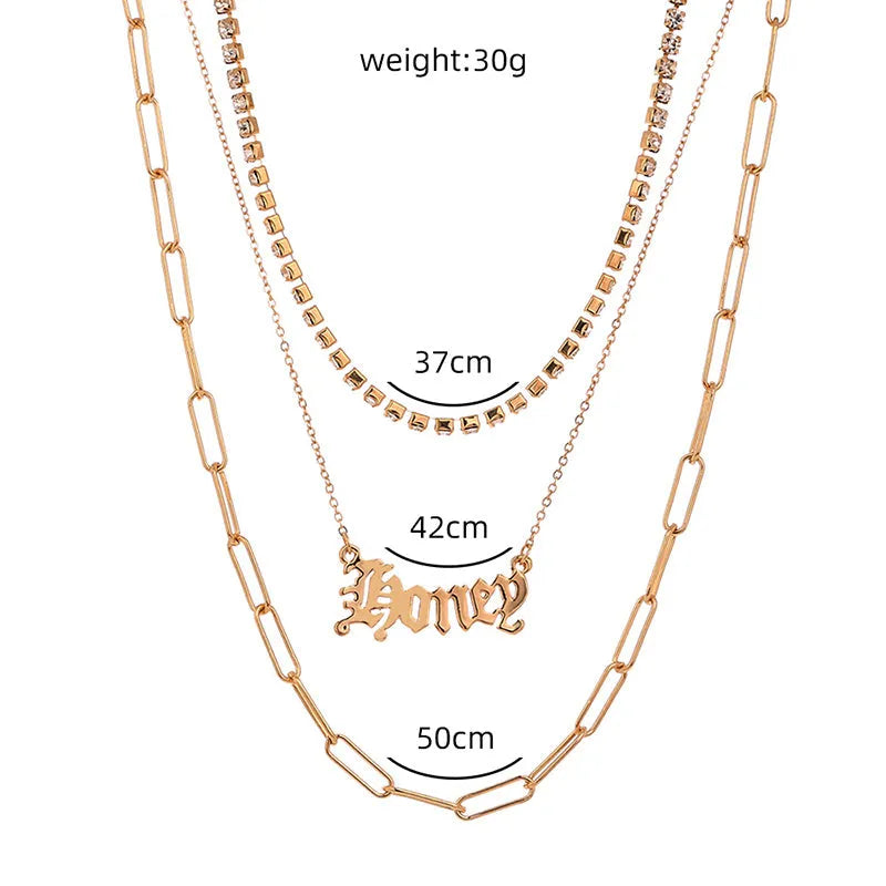 Monogram pendant multi-layer necklace on display showing electroplated zinc alloy chain and personalised initial