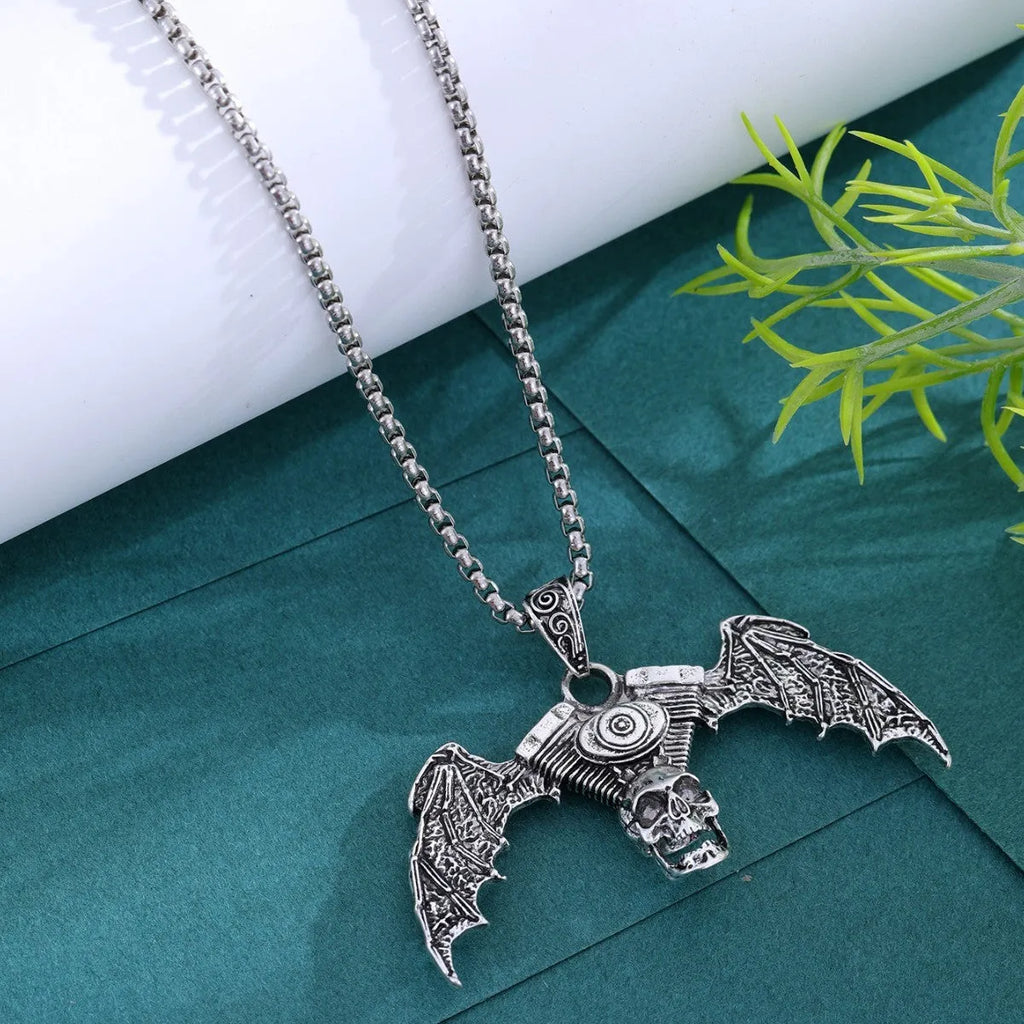 Gothic dark alloy skull pendant necklace with skeleton wing detail on matte black background