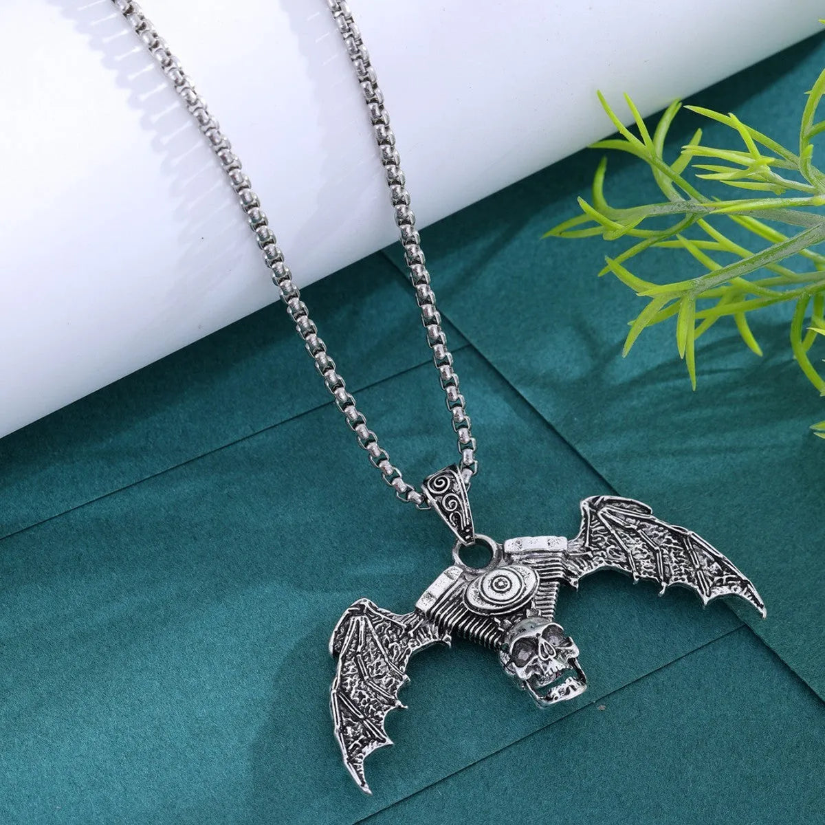 Gothic dark alloy skull pendant necklace with skeleton wing detail on matte black background