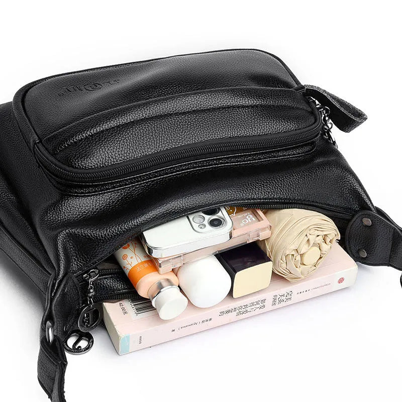 Large black women's crossbody shoulder bag with multiple internal compartments and zip closure