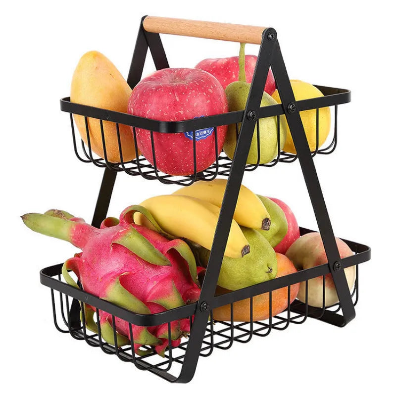 Black detachable iron double-layer fruit basket with a wooden carry handle on a tabletop.