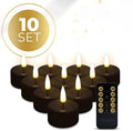 Set of four black battery-operated LED tealight candles with flickering flame effect
