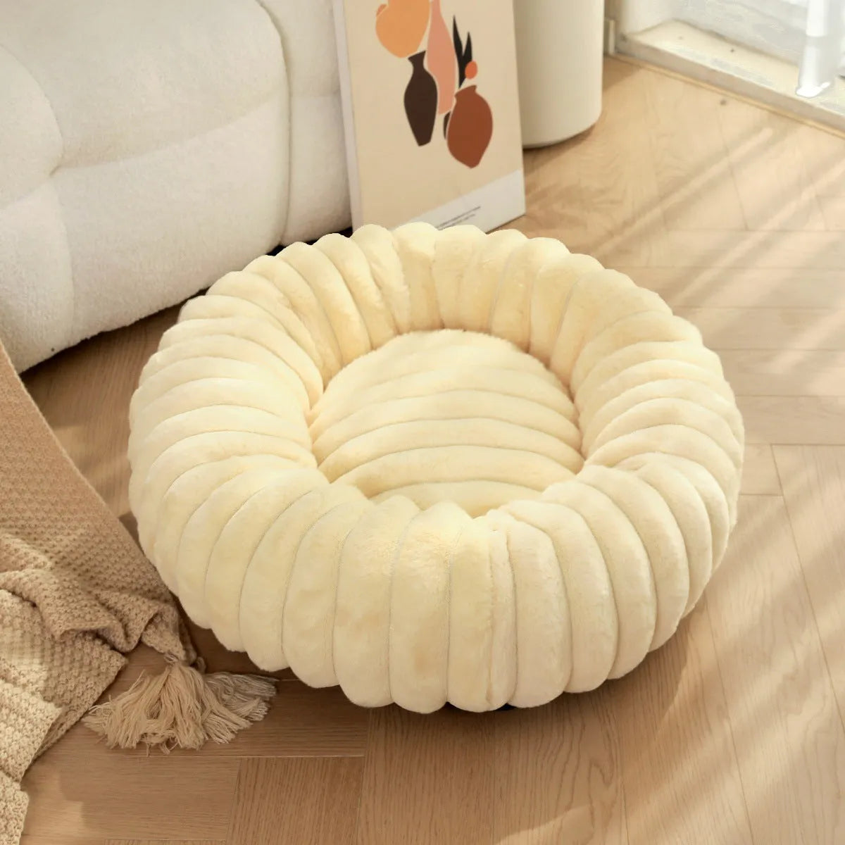 Round plush pet bed with long-hair rabbit fur style texture in beige colour