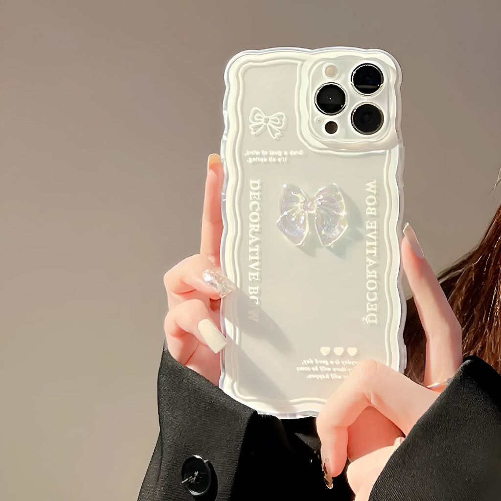 Clear flexible iPhone case with a raised 3D ice-through bow design on the back.