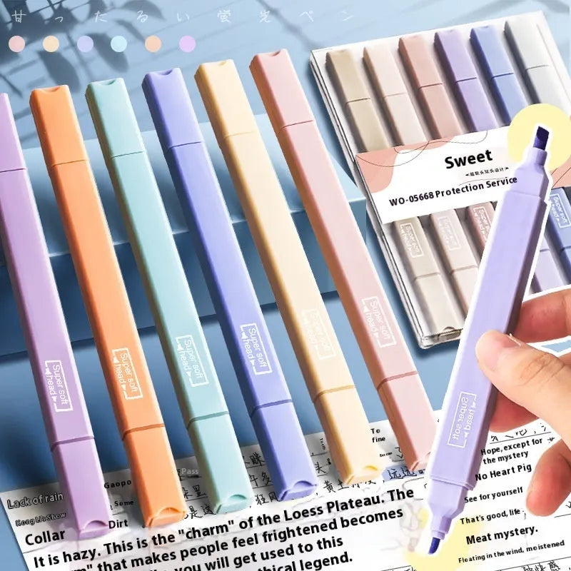 Set of double-headed fluorescent marking pens in bright colours on a white background.