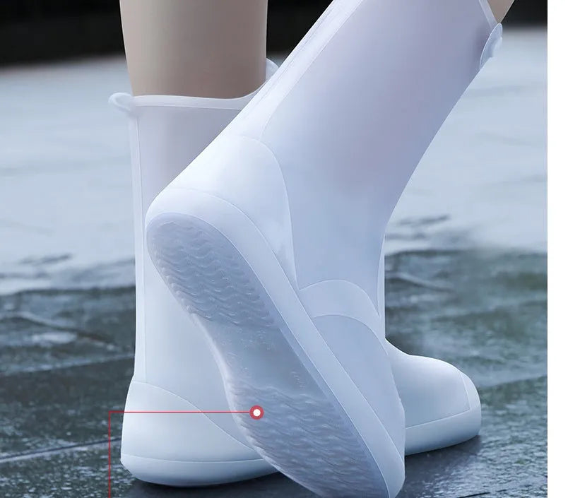 White high-top PVC reusable shoe covers for women, shown on feet.