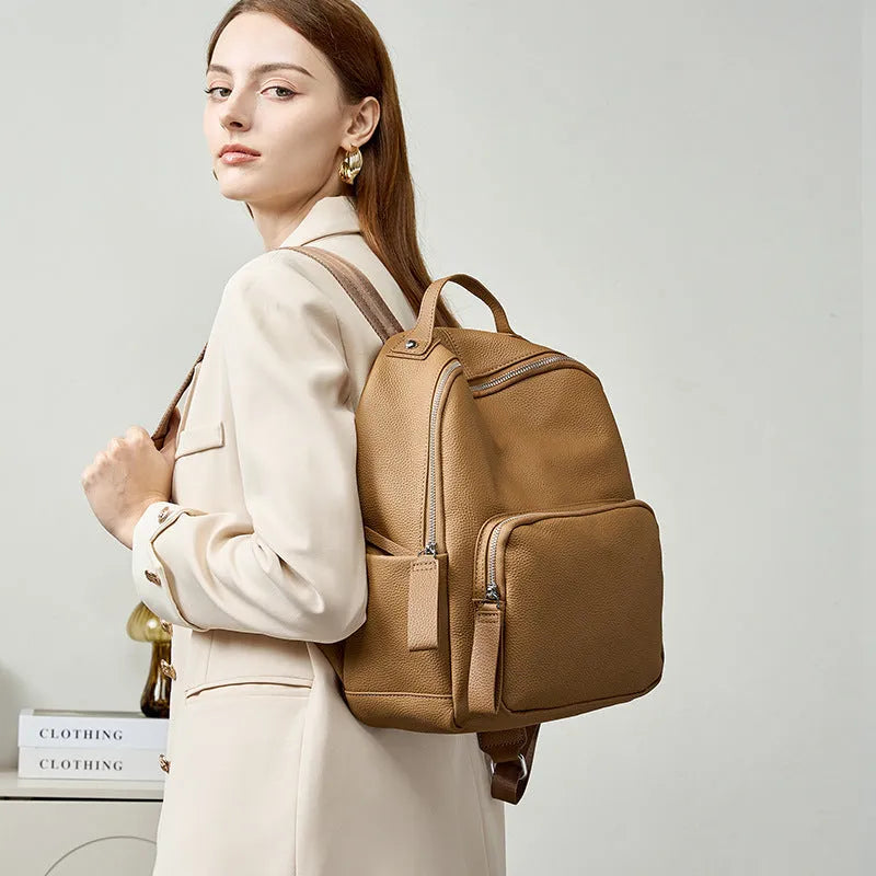 Genuine leather women's backpack showing laptop compartment and multiple colour options including black, brown and grey