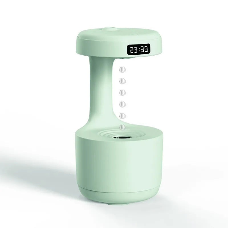 Rose gold and white columnar humidifier with levitating water drops and LED lighting on desk