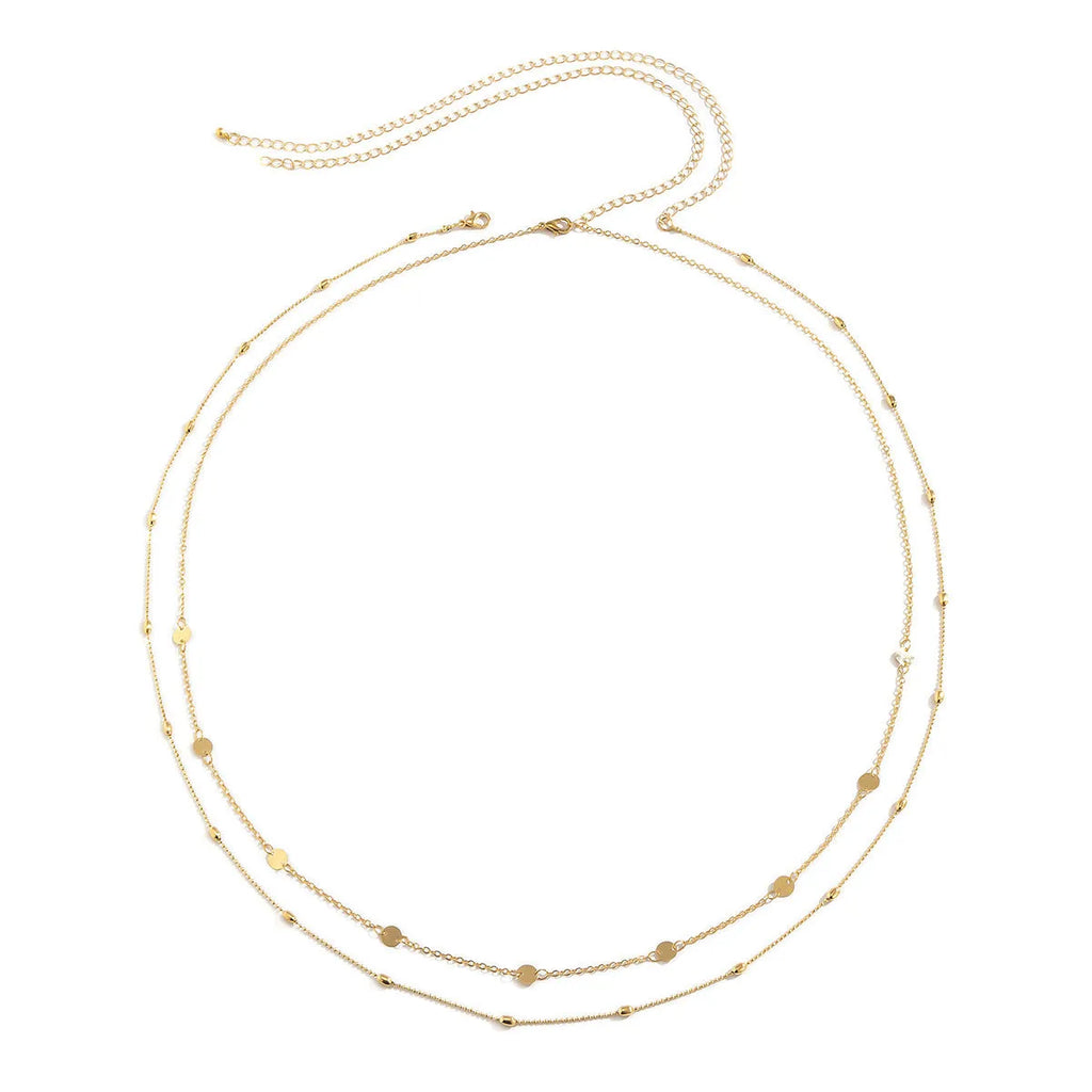 Gold double-layer belly chain with tassel detail and lobster clasp on a white background