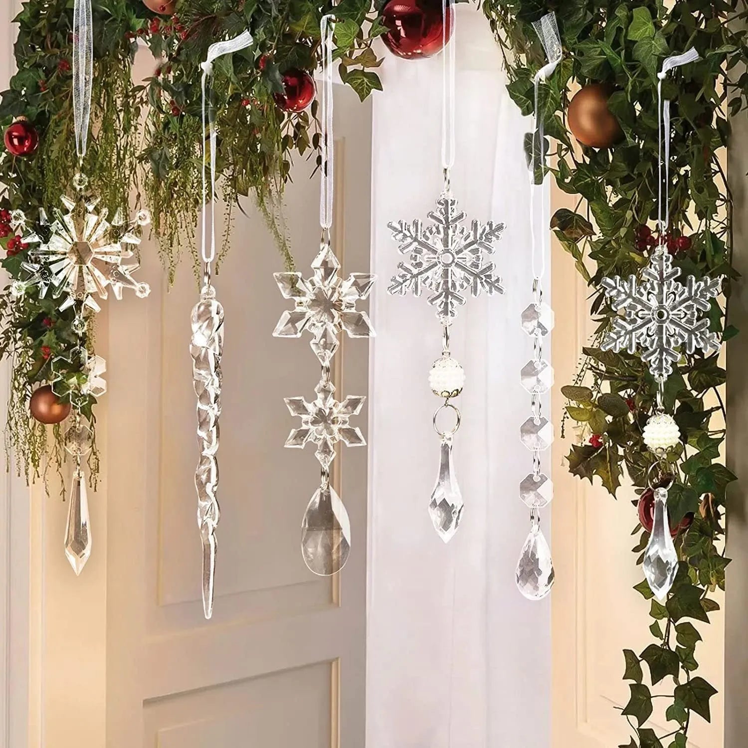 Ten clear acrylic icicle-shaped Christmas ornaments with white ribbons for hanging.