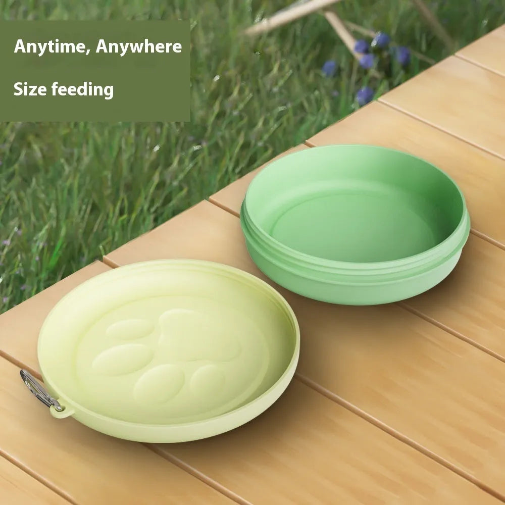 Collapsible silicone dog bowl in light pink, shown both folded flat and popped open, with separate lid next to it.