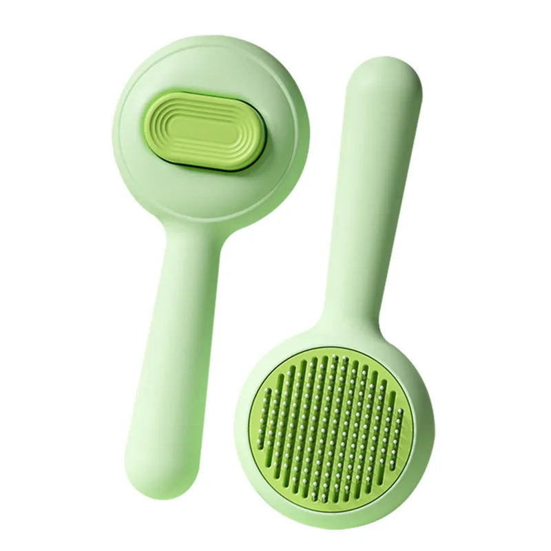 Green and yellow pet grooming brush with stainless steel teeth and a non-slip handle.