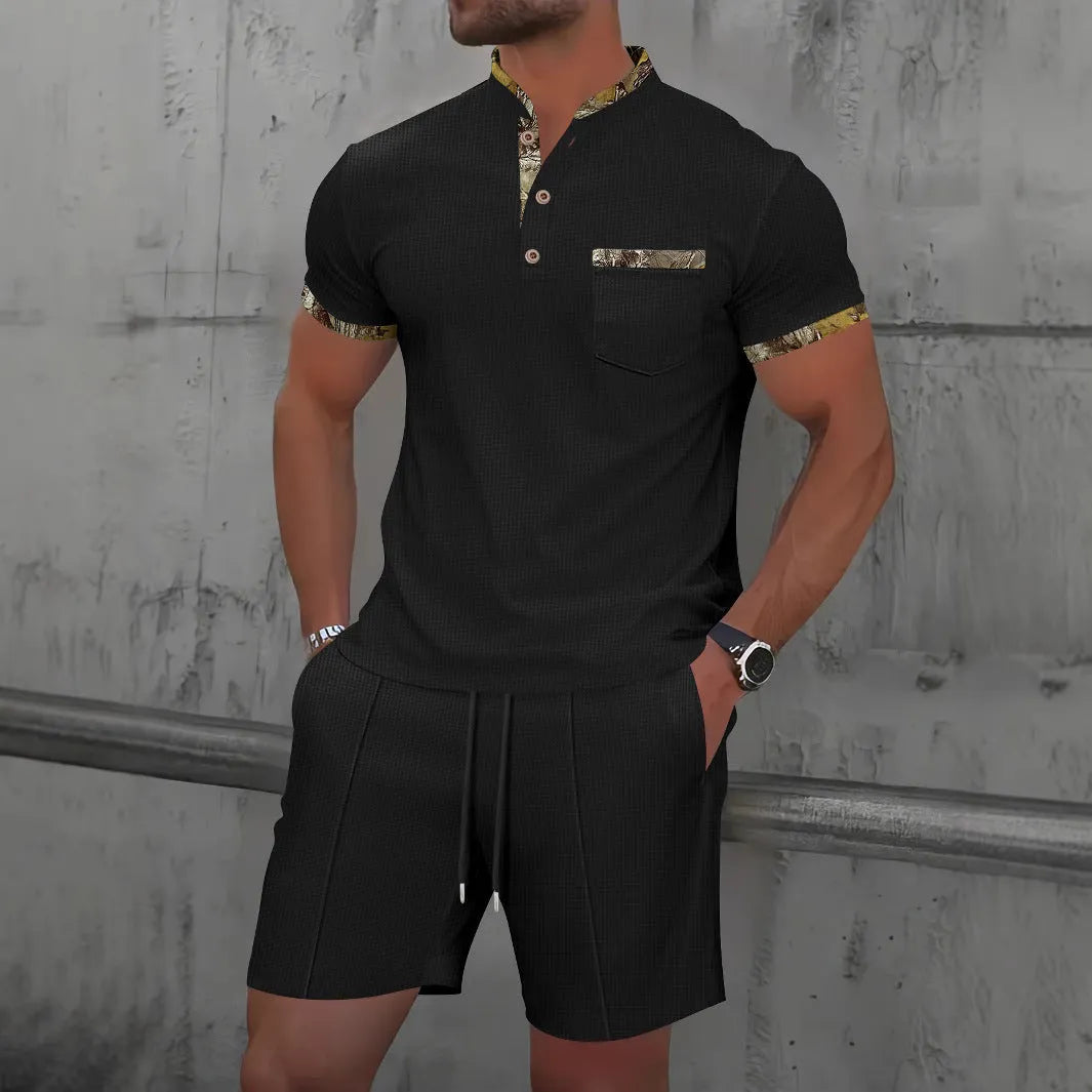 Men's grey zip-up polo collar short sleeve top and shorts tracksuit set laid flat.
