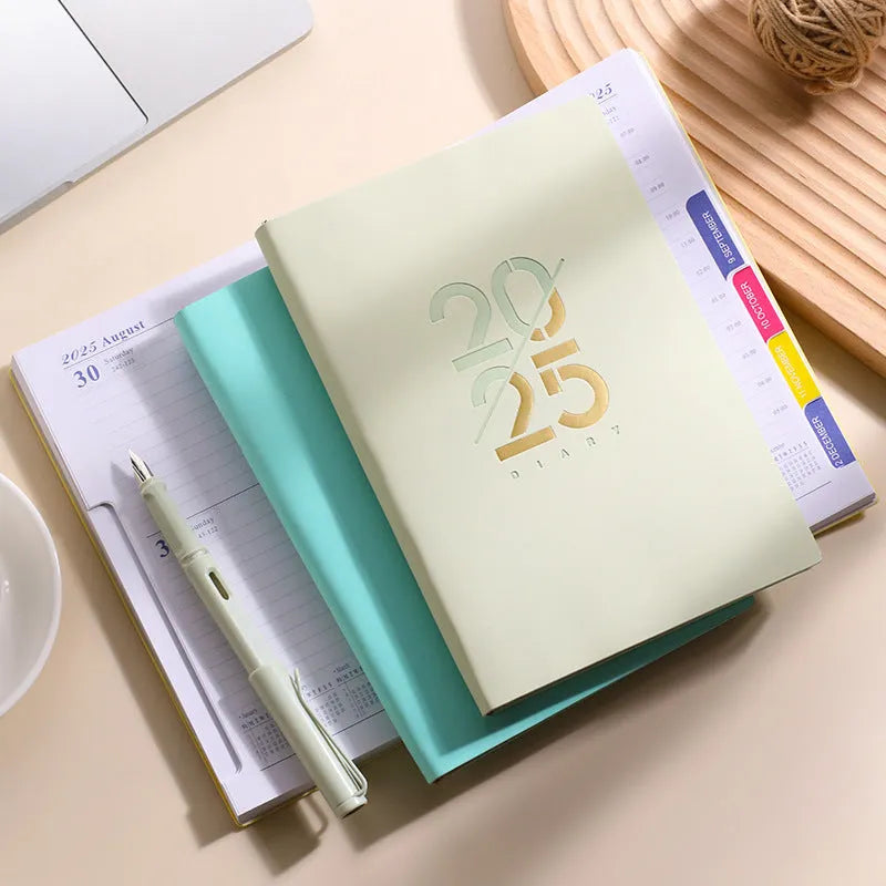 2025 A5 daily schedule book with soft faux leather cover, open to show weekly planner layout.