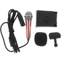 Portable 3.5mm mini karaoke microphone in rose gold with sponge head and stand on a table
