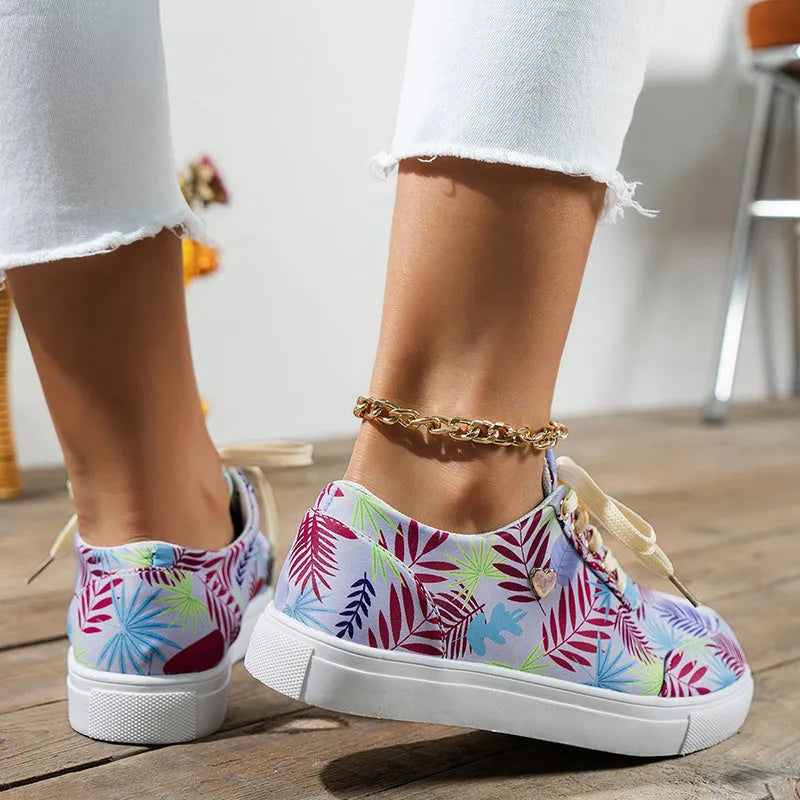 Light blue women's canvas lace-up flats with graffiti leaf print and round toe