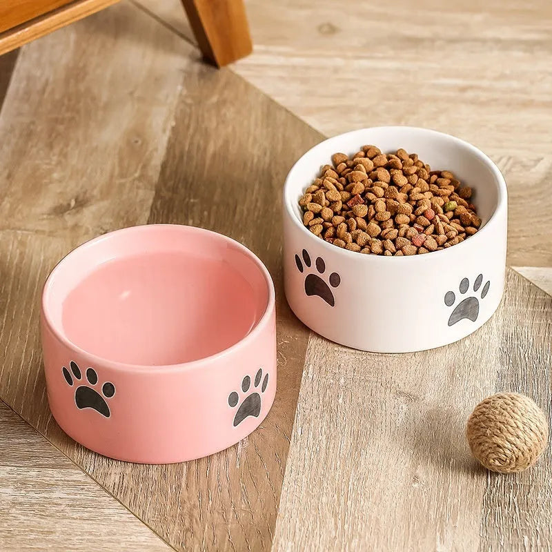 Ceramic cat bowl with cat paw design in black, showing oblique mouth style.