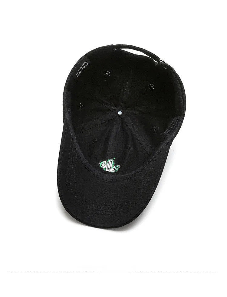 Cotton baseball cap with embroidered cartoon pattern in black, side view, unisex adjustable design