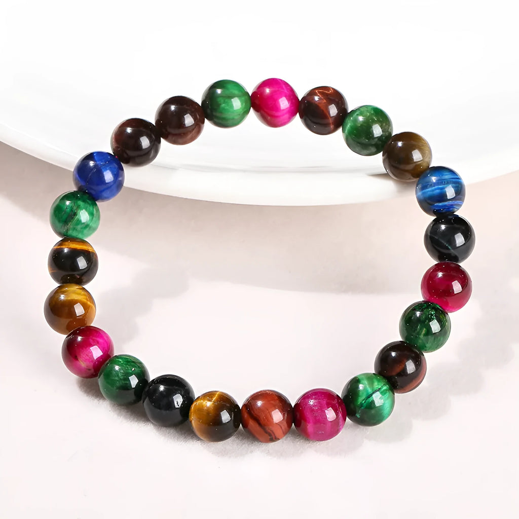 Colourful Tigereye natural stone bracelet with geometric round beads in multiple sizes on wrist