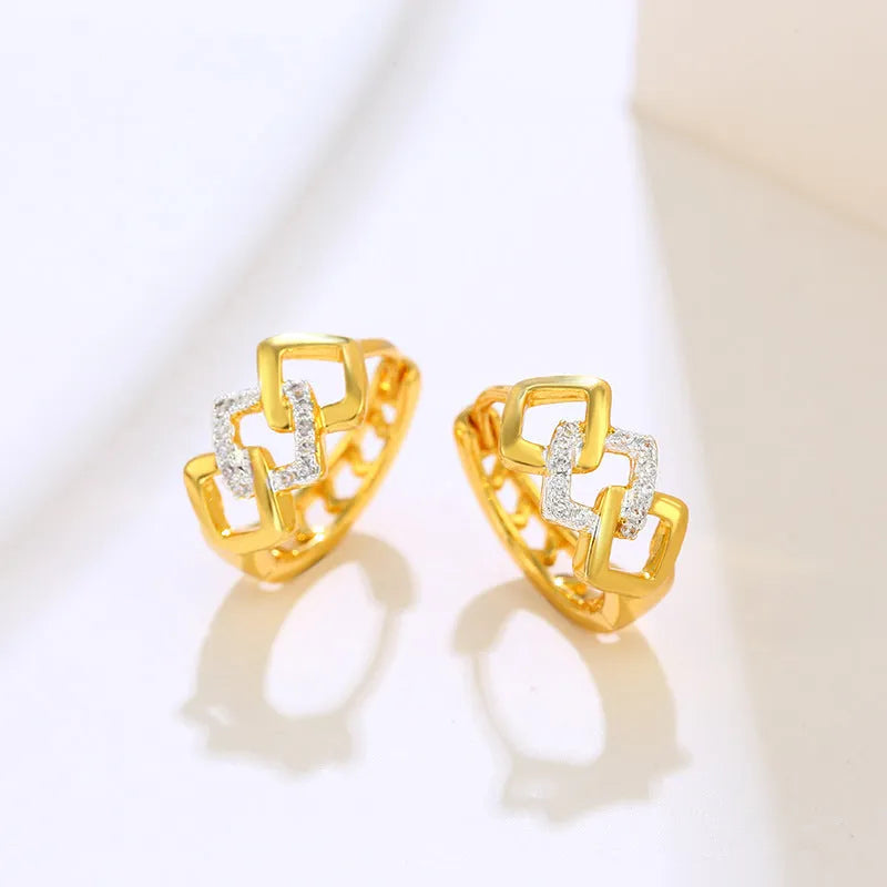 A pair of gold-coloured geometric alloy earrings with a hollow-out design.