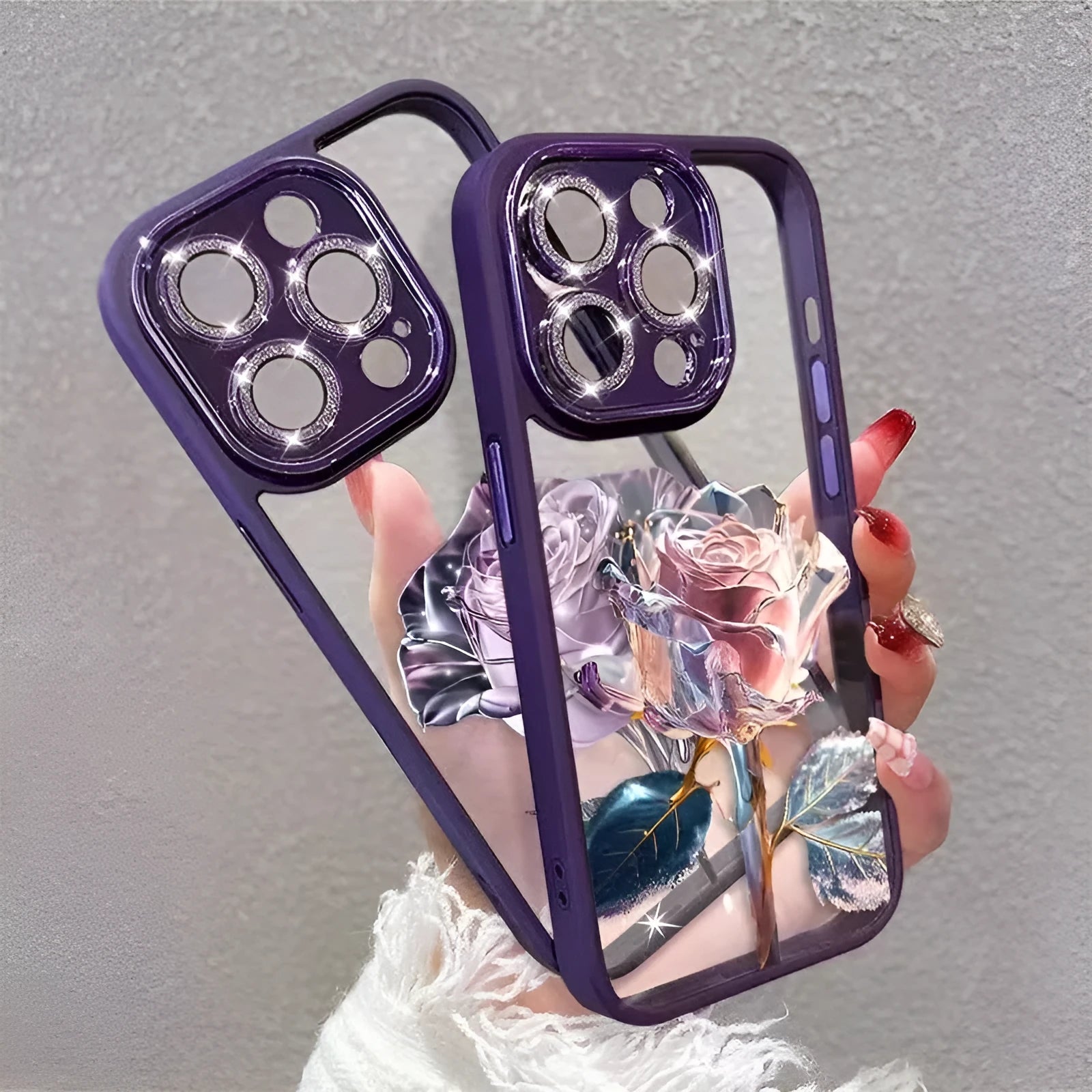 Dark purple TPU iPhone case with pink rose design and sparkling pink lens film over cameras.